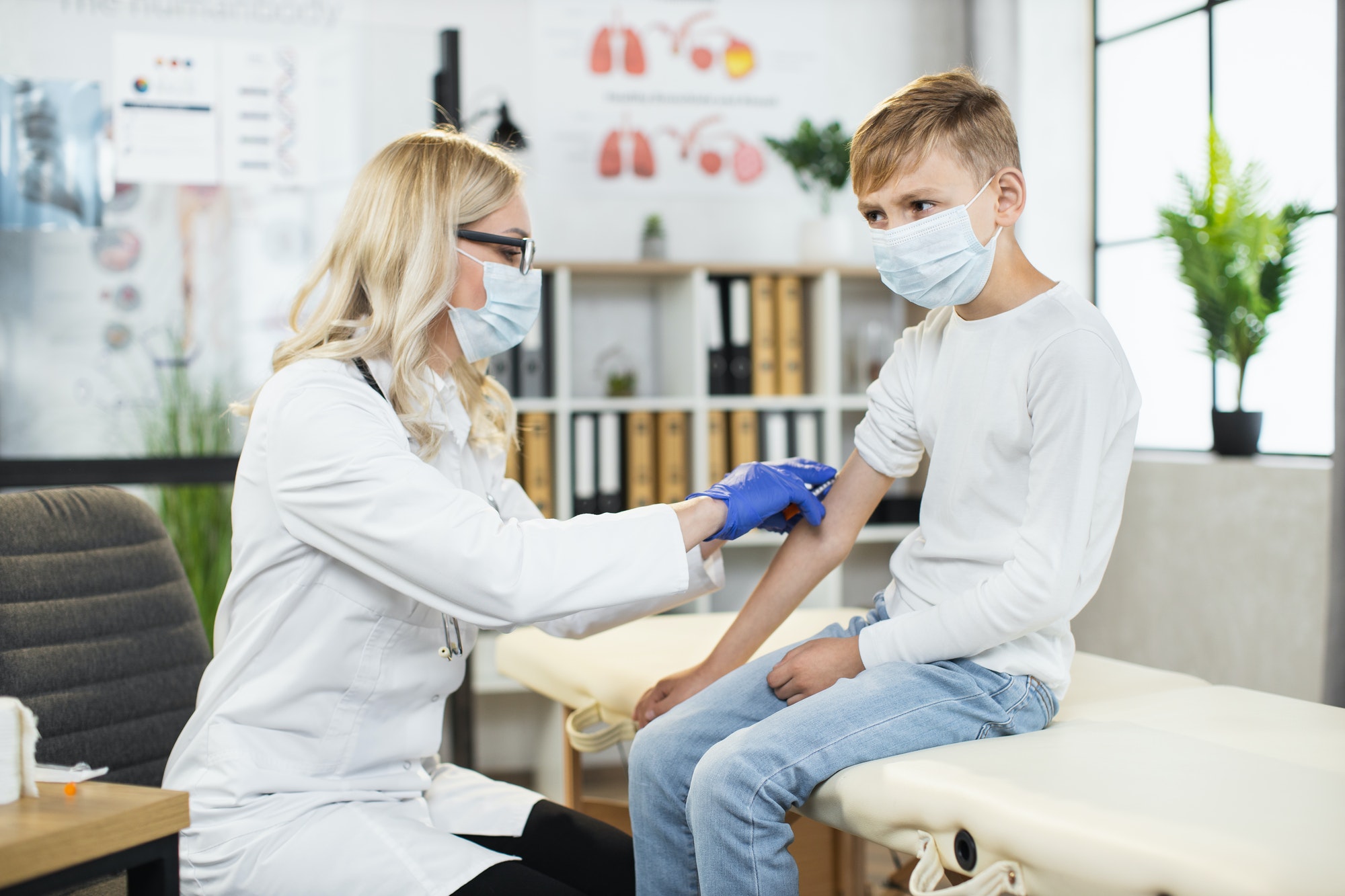 Female doctor doing vaccination for covid to male patient