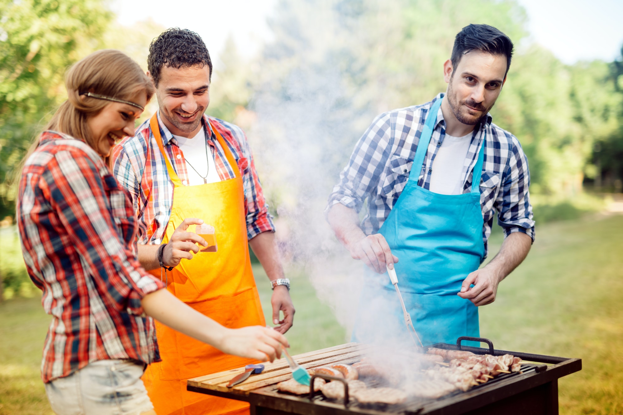 Young people grilling outdoors