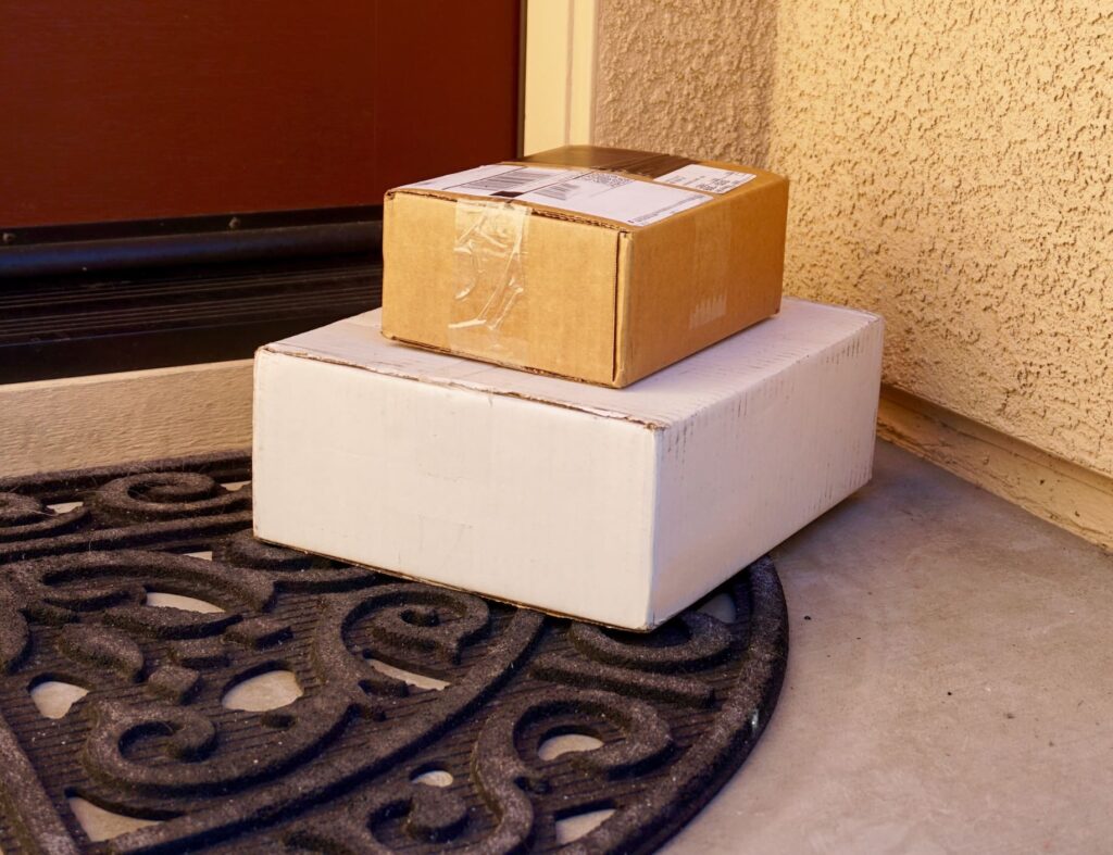 Delivered packages by a front door at a home