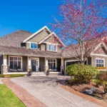 Home maintenance to keep beautiful home in spring and summer running. Home with driveway and flowering tree